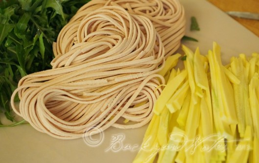 Arugula, stringozzi and yellow summer squash.