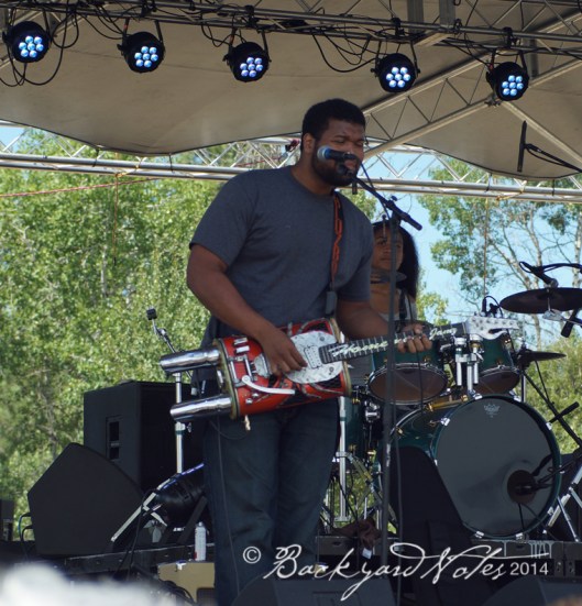 A member of Homemade Jamz playing his Muffler Guitar! (They were great.)
